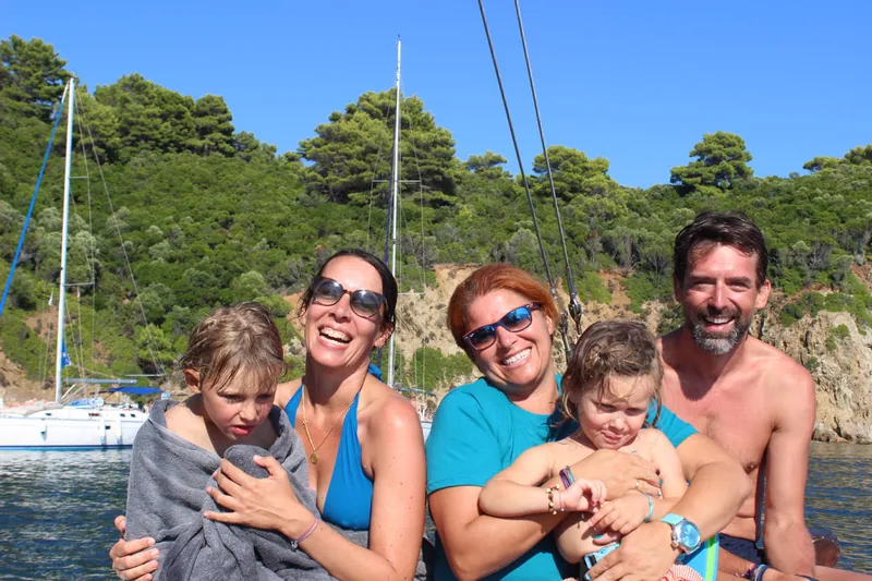 A family smiling on deck